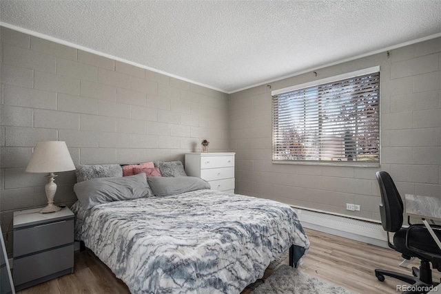 10115 W 25th Ave Unit 1, Lakewood, CO 80215 - bedroom with a textured ceiling, wood finished floors, crown molding, and concrete block wall