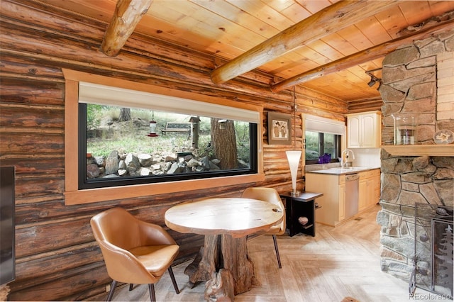 dining area featuring log walls, wooden ceiling, plenty of natural light, and beamed ceiling