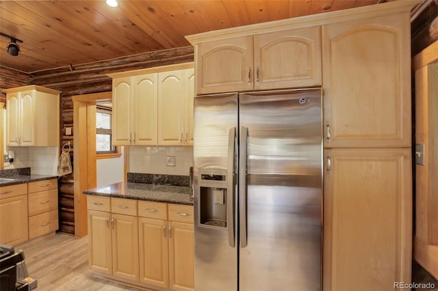 kitchen featuring tasteful backsplash, dark stone countertops, stainless steel fridge, light hardwood / wood-style floors, and wood ceiling