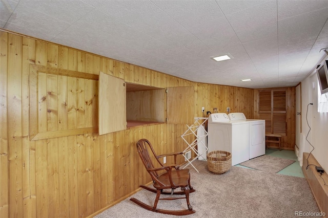 washroom featuring independent washer and dryer, carpet floors, and wooden walls