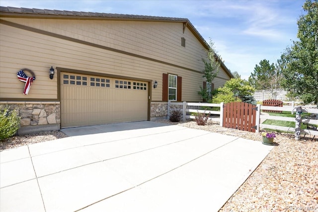 3419 Traver Dr, Broomfield, CO 80023 - exterior space with stone siding, a garage, fence, and driveway
