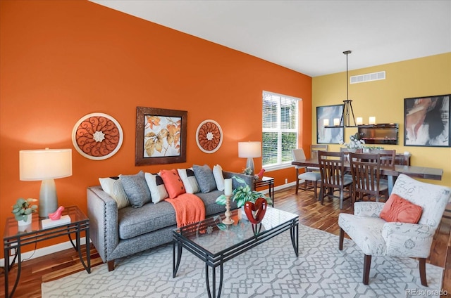 3419 Traver Dr, Broomfield, CO 80023 - living area featuring baseboards, visible vents, and wood finished floors