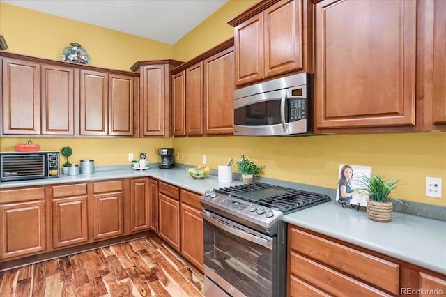 3419 Traver Dr, Broomfield, CO 80023 - kitchen with a toaster, light countertops, light wood-style flooring, and stainless steel appliances