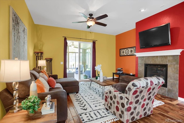 3419 Traver Dr, Broomfield, CO 80023 - living room with baseboards, a tiled fireplace, wood finished floors, and a ceiling fan