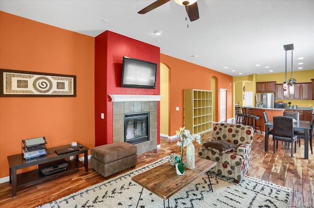 3419 Traver Dr, Broomfield, CO 80023 - living room with baseboards, a fireplace, wood finished floors, and a ceiling fan