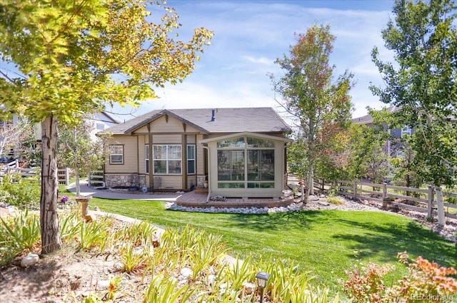 3419 Traver Dr, Broomfield, CO 80023 - back of property with stone siding, fence, and a yard