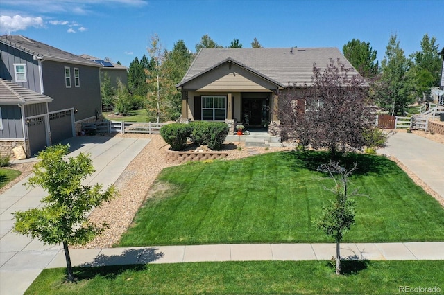 3419 Traver Dr, Broomfield, CO 80023 - view of front of house featuring a tile roof, concrete driveway, fence, a front lawn, and a garage