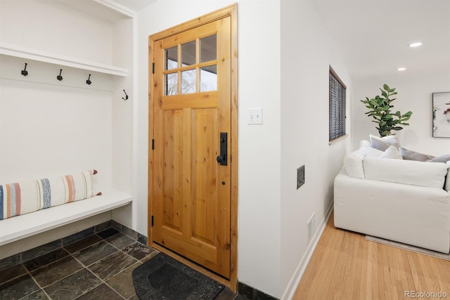 mudroom with stone finish floor, baseboards, visible vents, and recessed lighting