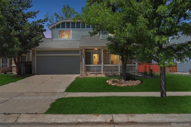 5229 Nighthawk Pkwy, Brighton, CO 80601 - view of front facade with concrete driveway, a garage, stone siding, covered porch, and roof with shingles