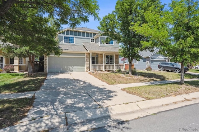 5229 Nighthawk Pkwy, Brighton, CO 80601 - view of front of home with a porch, driveway, a garage, and a front yard