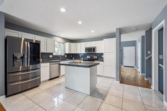 5229 Nighthawk Pkwy, Brighton, CO 80601 - kitchen featuring stainless steel appliances, white cabinetry, decorative backsplash, light tile patterned floors, and recessed lighting