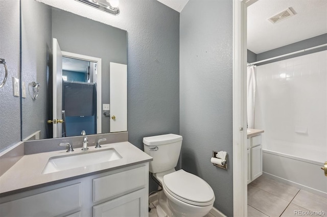 5229 Nighthawk Pkwy, Brighton, CO 80601 - bathroom with vanity, shower / bath combination with curtain, a textured wall, and tile patterned floors