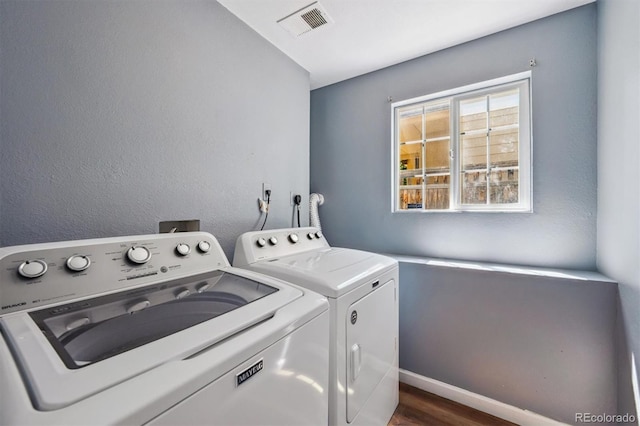 5229 Nighthawk Pkwy, Brighton, CO 80601 - washroom with separate washer and dryer and dark wood finished floors