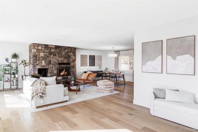 living room with light wood finished floors and a fireplace