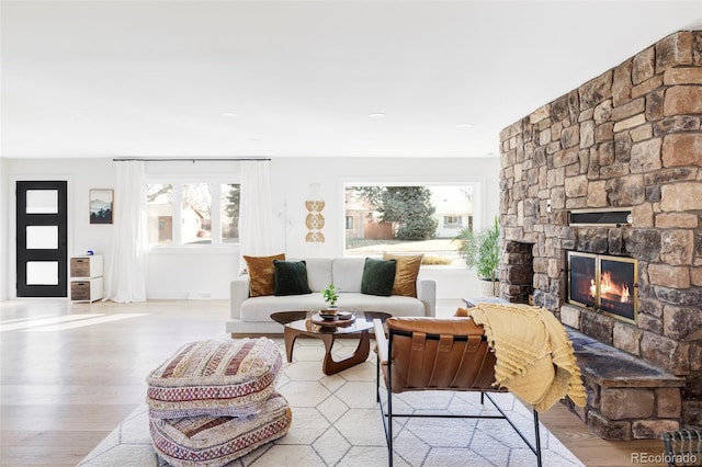 living room with a fireplace and wood finished floors