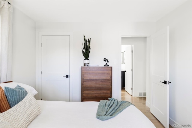 bedroom with visible vents and light wood-style floors