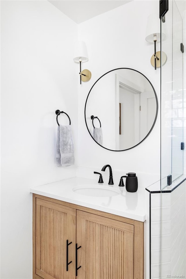 bathroom with a stall shower and vanity