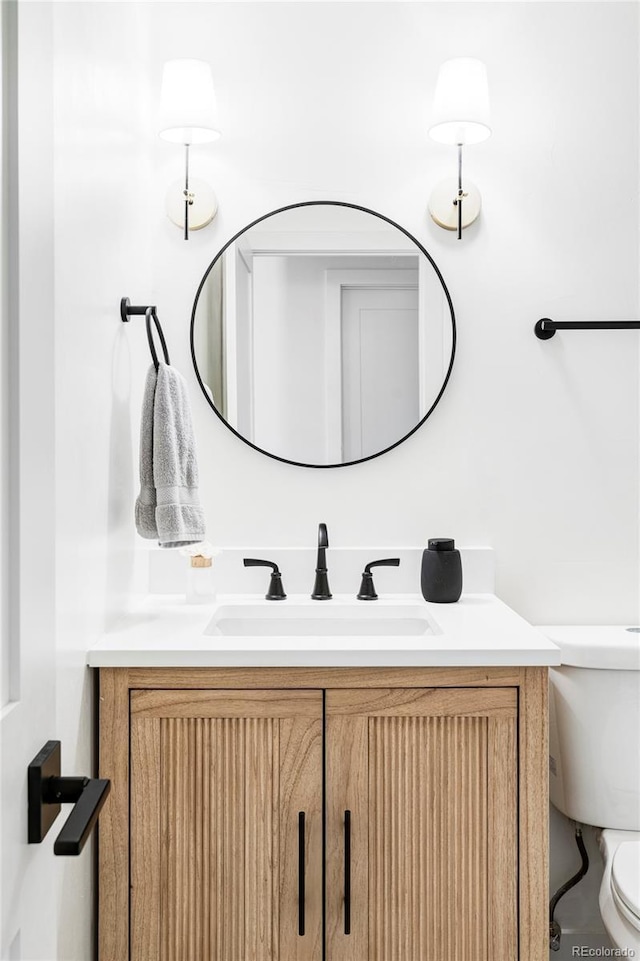 bathroom with vanity and toilet