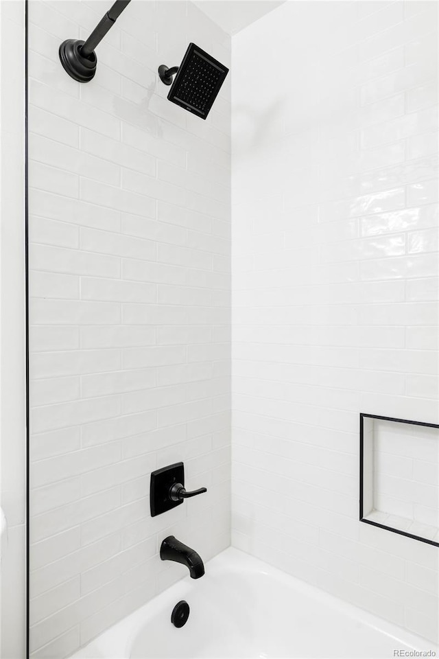 interior details featuring bathtub / shower combination