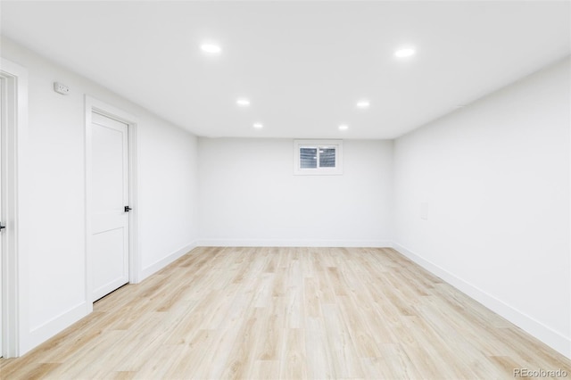 spare room with baseboards, recessed lighting, and light wood-style floors