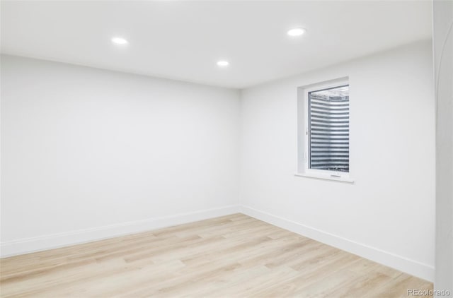 unfurnished room with light wood-type flooring, baseboards, and recessed lighting