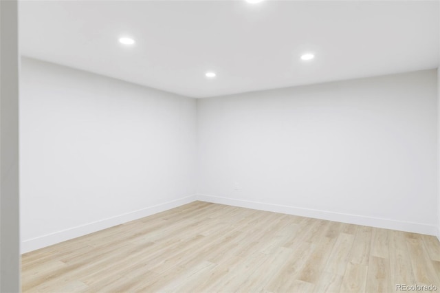 spare room featuring baseboards, recessed lighting, and light wood-style floors