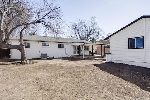 rear view of property with a patio area, french doors, and central AC unit