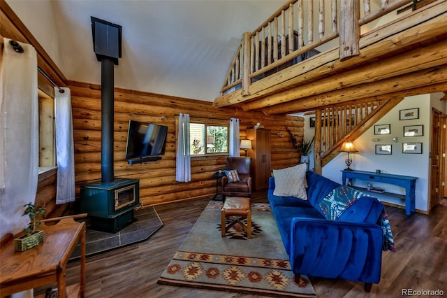 living room with a wood stove, high vaulted ceiling, dark wood-type flooring, and log walls