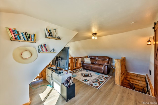 living room featuring light hardwood / wood-style flooring and lofted ceiling