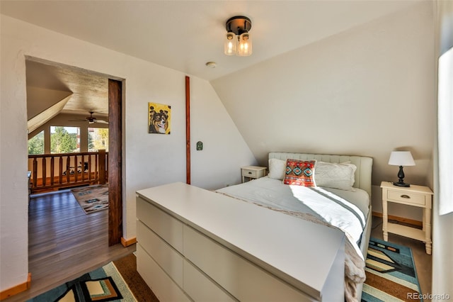 bedroom featuring lofted ceiling and dark wood-type flooring