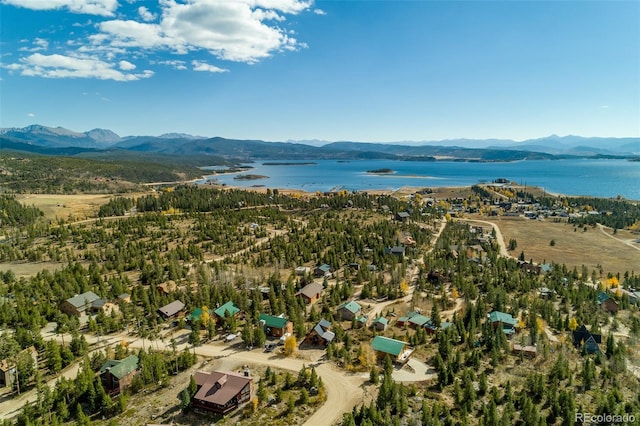 drone / aerial view featuring a water and mountain view