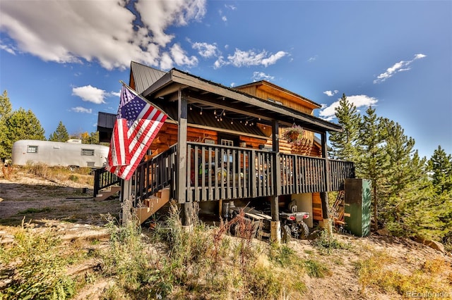 back of property featuring a wooden deck