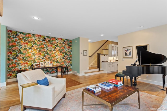 1479 S Clarkson St, Denver, CO 80210 - living area with wallpapered walls, stairs, light wood finished floors, an accent wall, and recessed lighting
