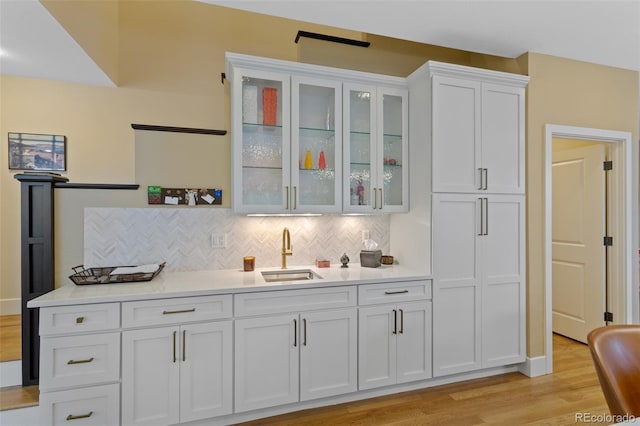 1479 S Clarkson St, Denver, CO 80210 - indoor wet bar featuring light wood-style flooring and tasteful backsplash