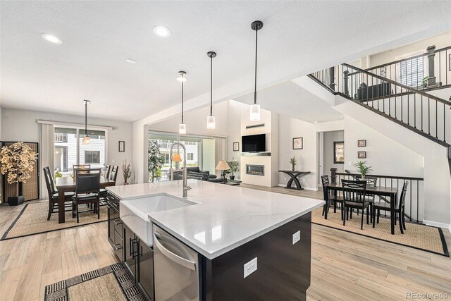 5621 Loma Vista Dr, Parker, CO 80134 - kitchen featuring dishwasher, light wood-type flooring, pendant lighting, and a sink