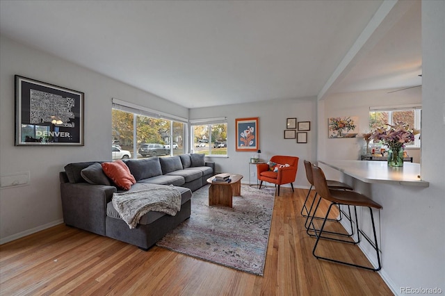 living room with ceiling fan, light hardwood / wood-style floors, and plenty of natural light