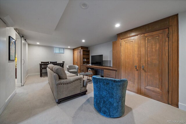 living room with a barn door and light carpet