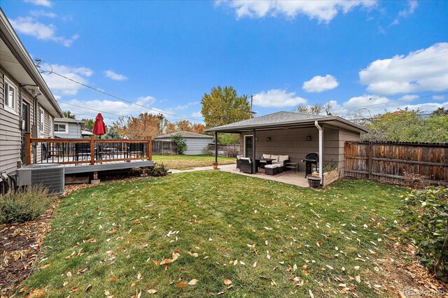 view of yard featuring central AC unit, outdoor lounge area, a patio, and a wooden deck