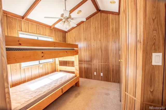 unfurnished bedroom with carpet flooring, wooden walls, and lofted ceiling with skylight