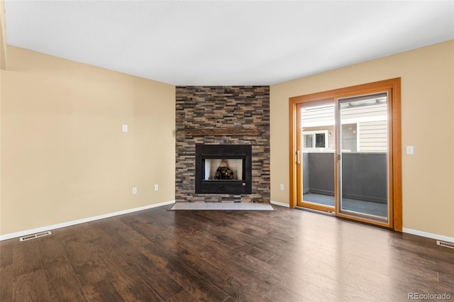 6730 W 84th Cir Unit 96, Arvada, CO 80003 - unfurnished living room with baseboards, wood finished floors, a fireplace, and visible vents