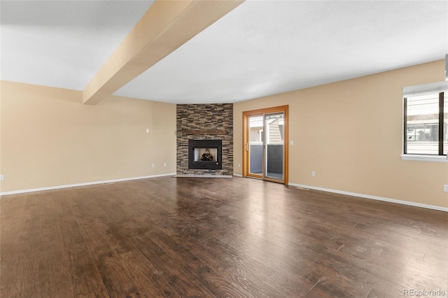 6730 W 84th Cir Unit 96, Arvada, CO 80003 - unfurnished living room with a fireplace, a wealth of natural light, and dark wood finished floors