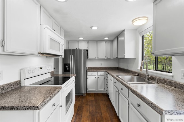 6730 W 84th Cir Unit 96, Arvada, CO 80003 - kitchen featuring a sink, white cabinets, dark wood-type flooring, white appliances, and recessed lighting