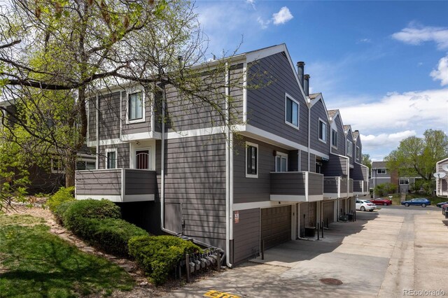 6730 W 84th Cir Unit 96, Arvada, CO 80003 - view of side of property featuring a balcony, a residential view, and a garage