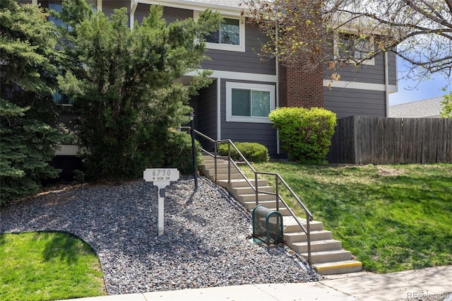 6730 W 84th Cir Unit 96, Arvada, CO 80003 - view of front of house with a front yard and fence