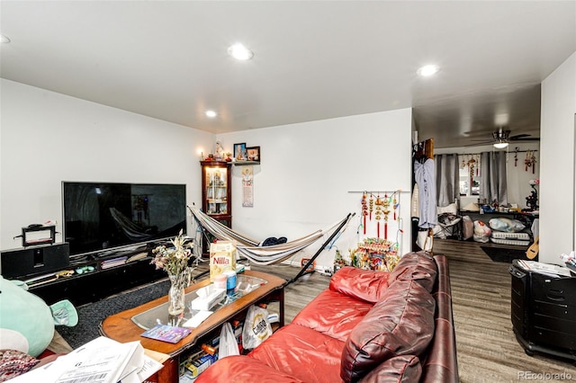 living room featuring hardwood / wood-style floors and ceiling fan