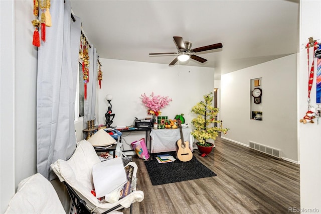 living room with ceiling fan and hardwood / wood-style flooring