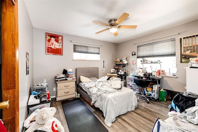 bedroom with hardwood / wood-style floors and ceiling fan