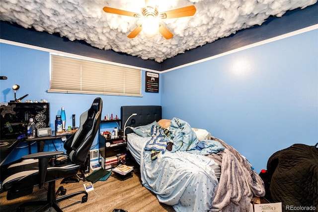 bedroom with ceiling fan and hardwood / wood-style floors