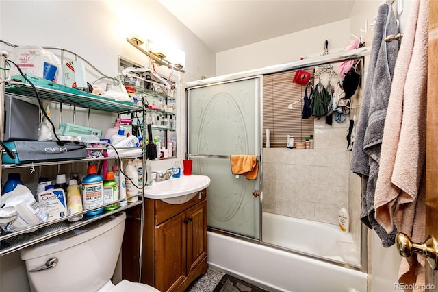 full bathroom with vanity, toilet, and bath / shower combo with glass door