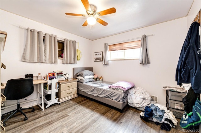 bedroom with dark wood-type flooring and ceiling fan